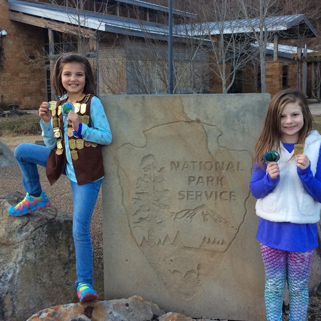 two girls with Junior Ranger badges