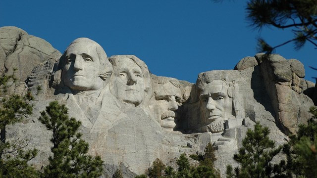 four male faces carved into a mountain