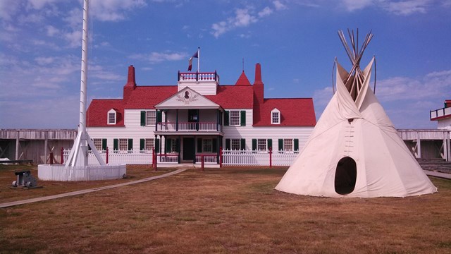 White fort with teepees in front of it