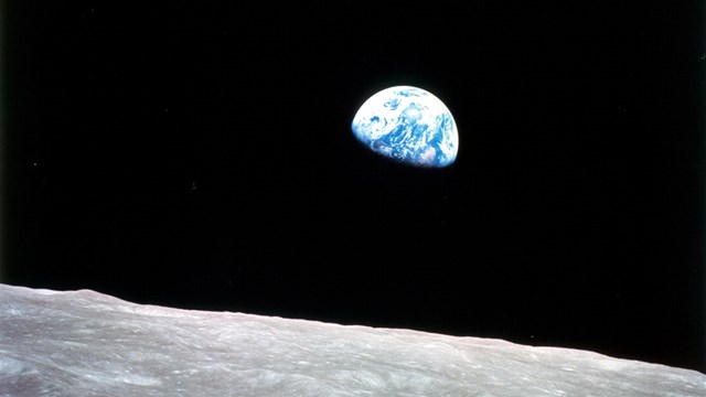 Advancing Scientific Research is typed across the surface of the moon and earth