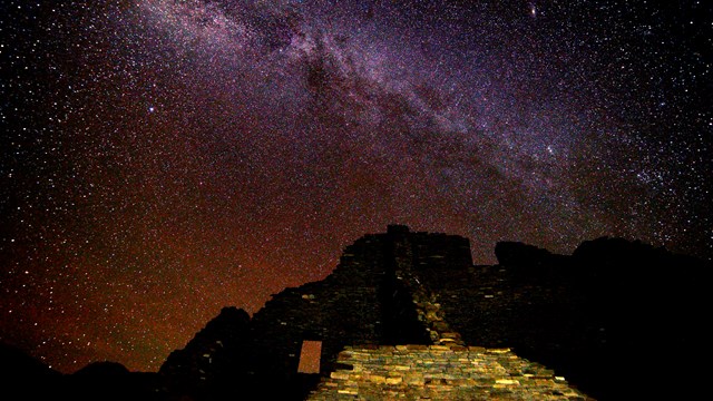 Night sky view of Milky Way above Puebloan ancestral ruins.