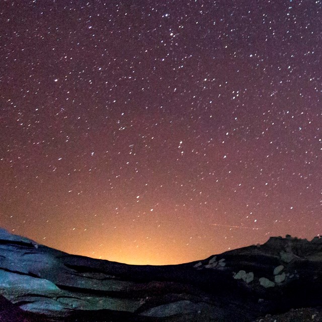 the glow of light pollution in a night sky