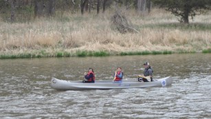 Two children and an adult enjoy canoeing on the Niobrara National Scenic River.
