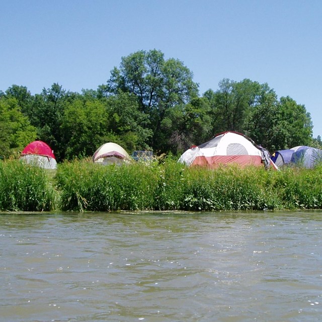 Many tents on a riverside