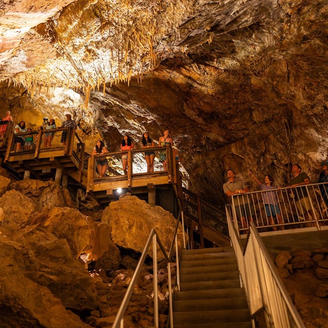 Glencoe Caves staircase with people