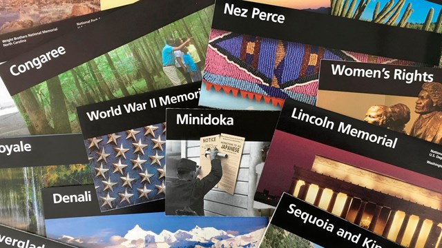 several national park service brochures arrayed on a table