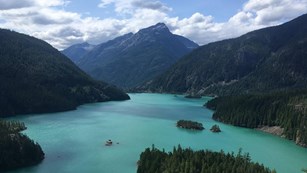 A blue lake surrounded by mountains.