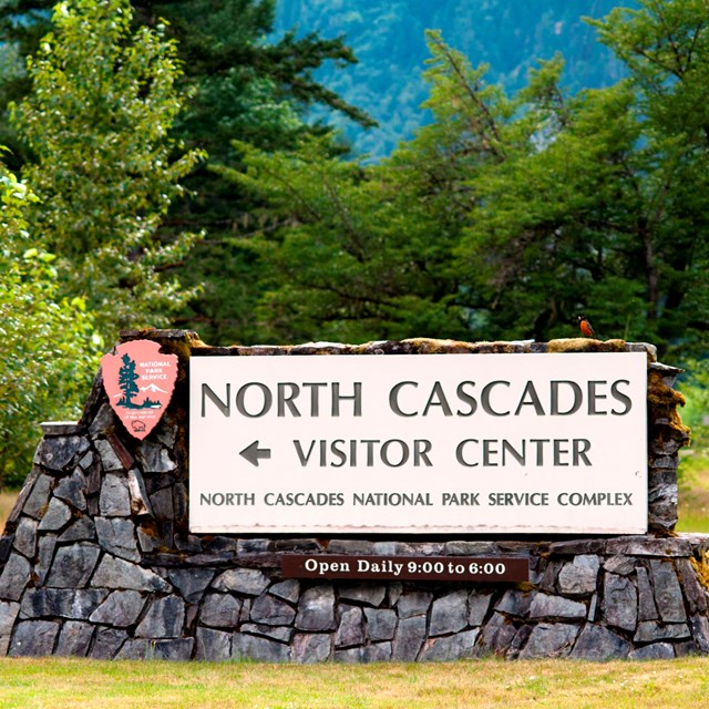 A stone and wood sign for the North Cascades Visitor Center.