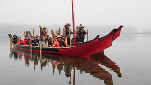 Group riding in a canoe in the mist