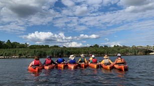 Group of linked kayakers in a river