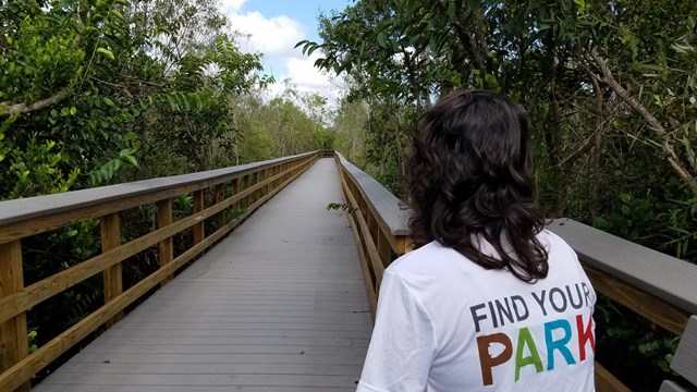 Person wearing a Find Your Park shirt on a boardwalk