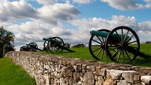 19th-century cannons along a stone wall