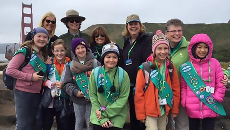A group of park rangers and girl scouts near the Gold Gate Bridge