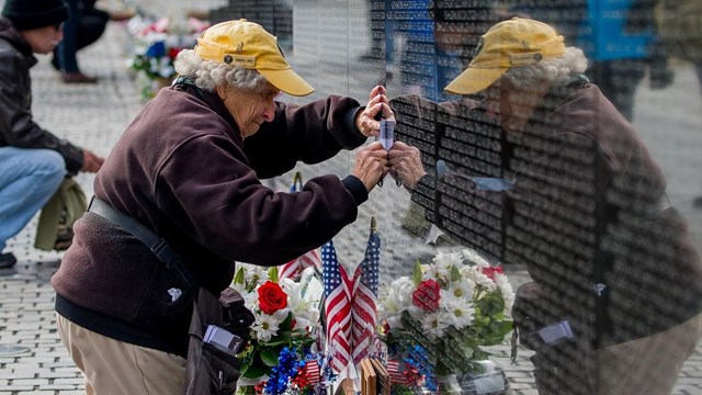 Volunteer cleaning the Vietnam Veterans Memorial wall