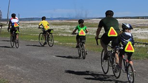 Family bicycling with safety equipment