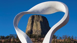 Smoke sculpture framing a butte-like geological formation