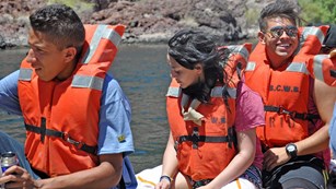 Group of youth wearing life jackets on a boat