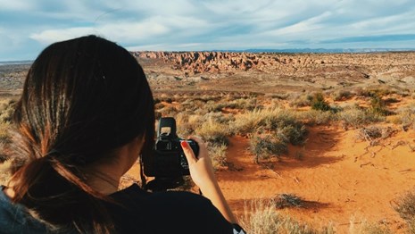 Photographer taking pictures of a desert