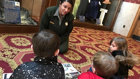 Ranger sitting on the floor talking to kids