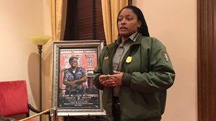 Ranger talking next to a portrait of Mary McLeod Bethune