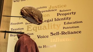 Suffragist cloak and hat in an exhibit