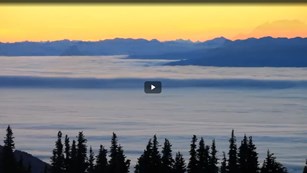 Screenshot from a film of the ocean near a mountain range