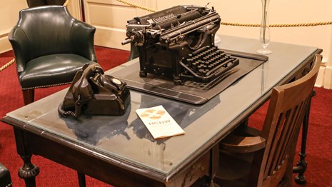 Desk with a typewriter and old telephone