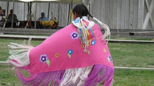 Native shawl dancer wearing a pink shawl