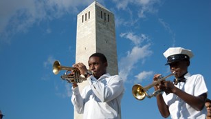Two musicians holding trumpets