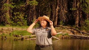 Ranger smiling in a wetlands area