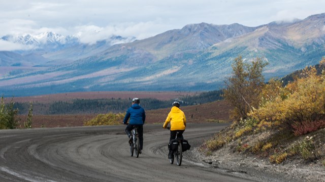 Two bicyclist on a gravel road in the mountains