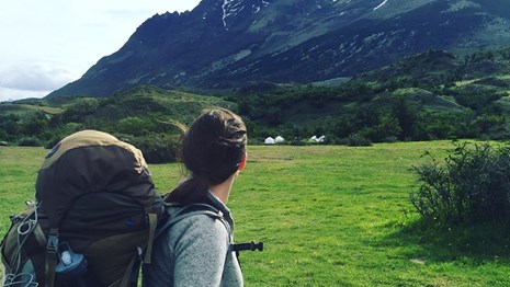Backpacker looking at a mountain in the distance