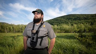 Biologist standing in a grass field