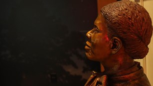 Face of a metal statue of Harriet Tubman