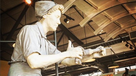 Statue of a World War II-era woman welding
