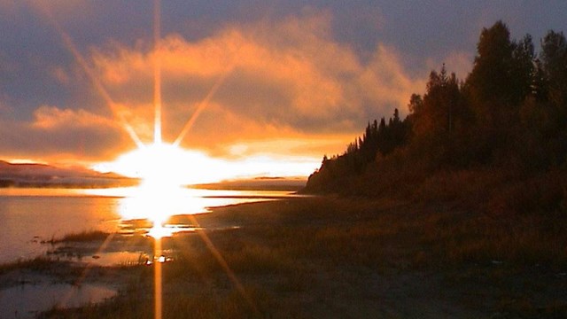 Sunrise over a river and mountain 