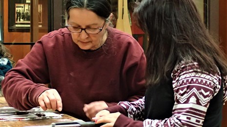 A cultural educator working nwith a child on an art project