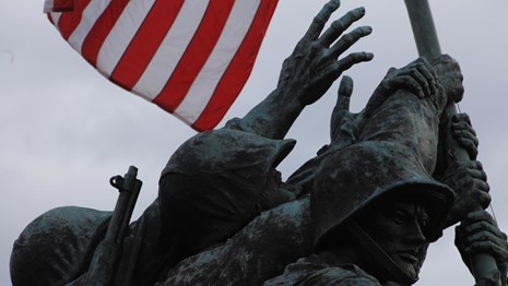 Statue of Marines' hands holding up a US flag
