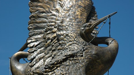 Metal statue of a crane