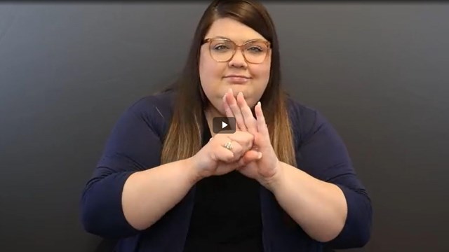 Video screenshot of a person using sign language 