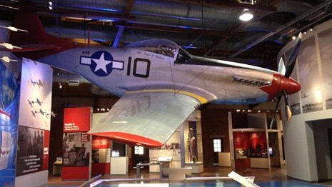 World War II-era military plane hanging in a museum exhibit