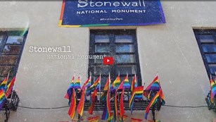 Screenshot of the Stonewall Inn decorated in LBGTQ pride flags