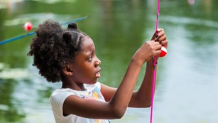 Kid hooking a fishing pole