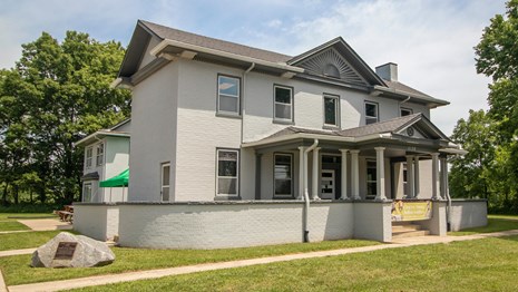 Two-story white house on a big lawn