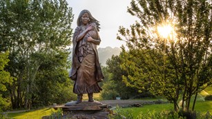 Statue of Sacagawea in a park garden