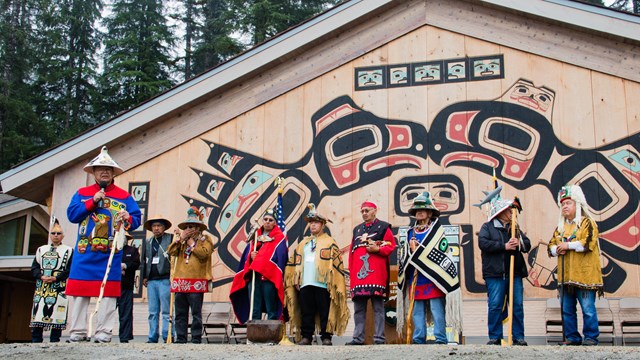 People standing outside the Xunaa Shuká Hít
