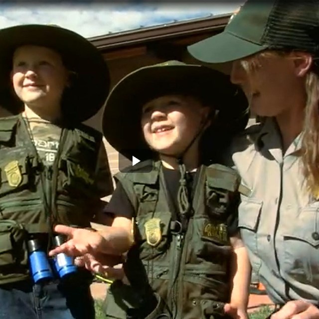 Video screenshot of ranger talking to Junior Rangers 