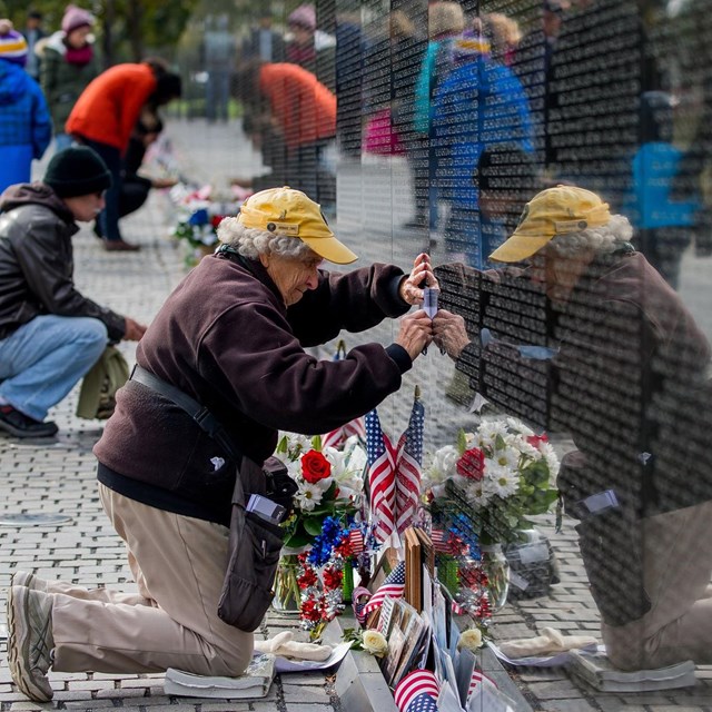 Volunteer cleaning the Vietnam Veterans Memorial wall