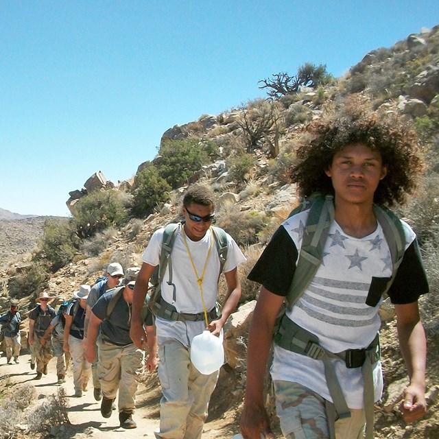 Youth Conservation Corps team walking on a desert trail