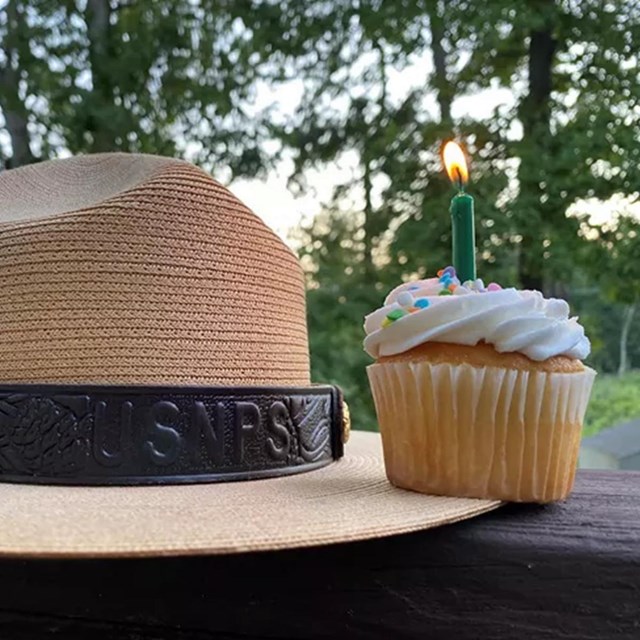 Ranger hat and birthday cupcake with a candle